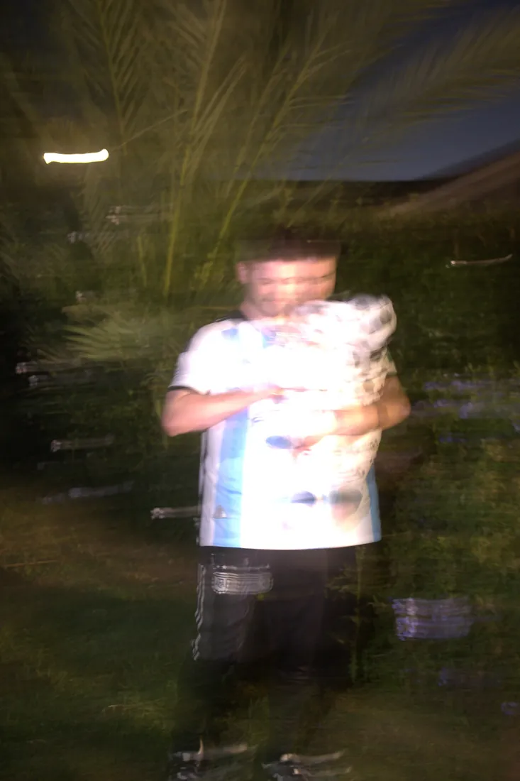Cameron holding Calix in their soccer costumes