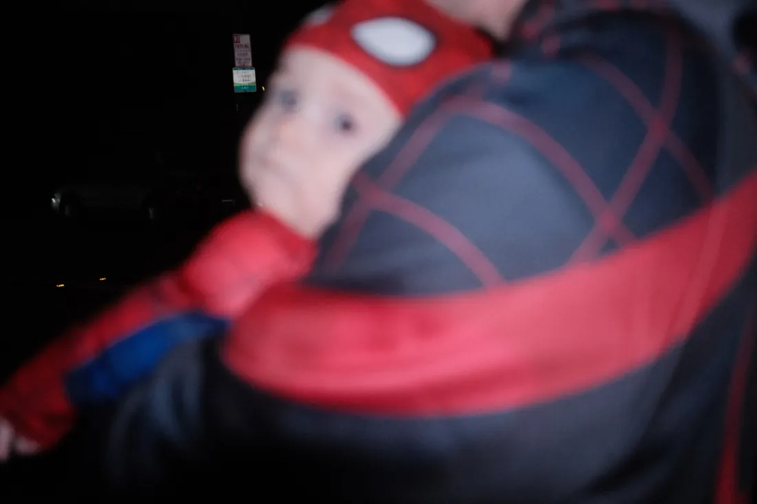 Calix reaching toward a Spider-Man costume