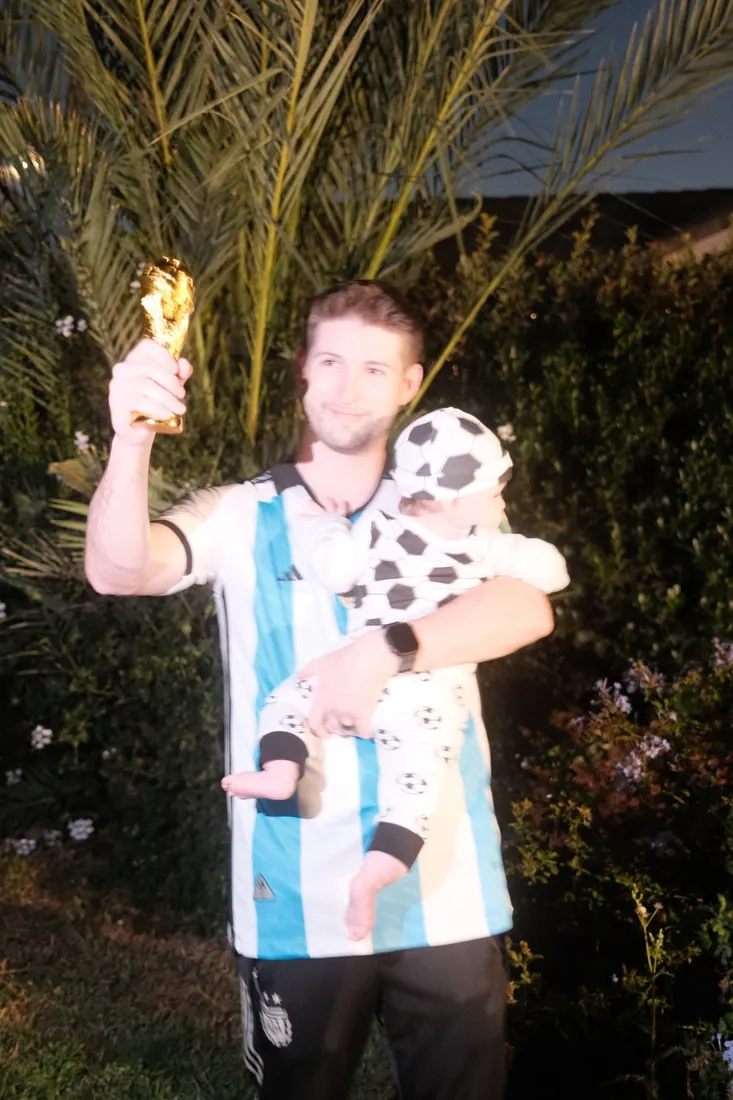 Cameron holding Calix and a gold soccer trophy