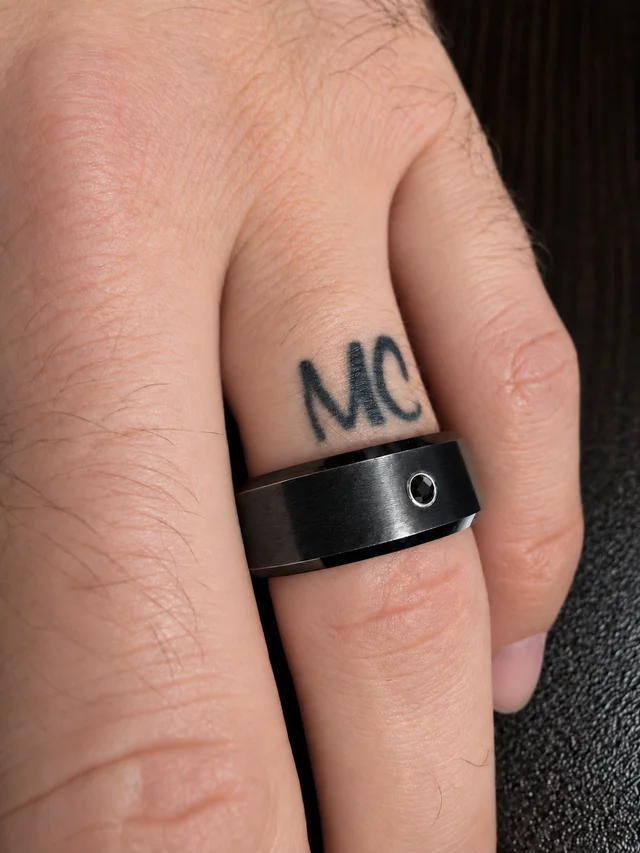 Cameron's black diamond wedding band and honeymoon tattoo